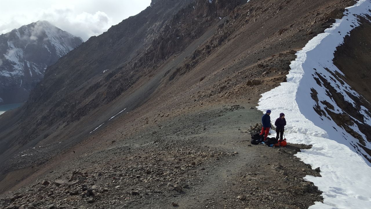 Two sides of the pass, on the left, sunny lakeside, on the right, dark, snowy, stormy