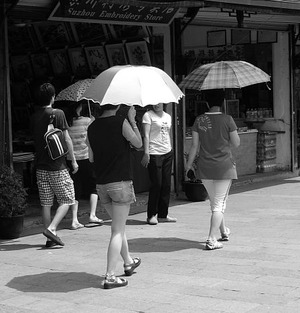 people with umbrellas on sunny day